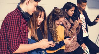 A group of young people on their phones