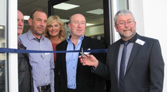 A man cutting a ribbon