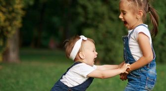 Two sisters playing in the park