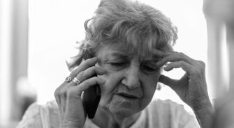 Shot of a tired senior woman using a mobile phone