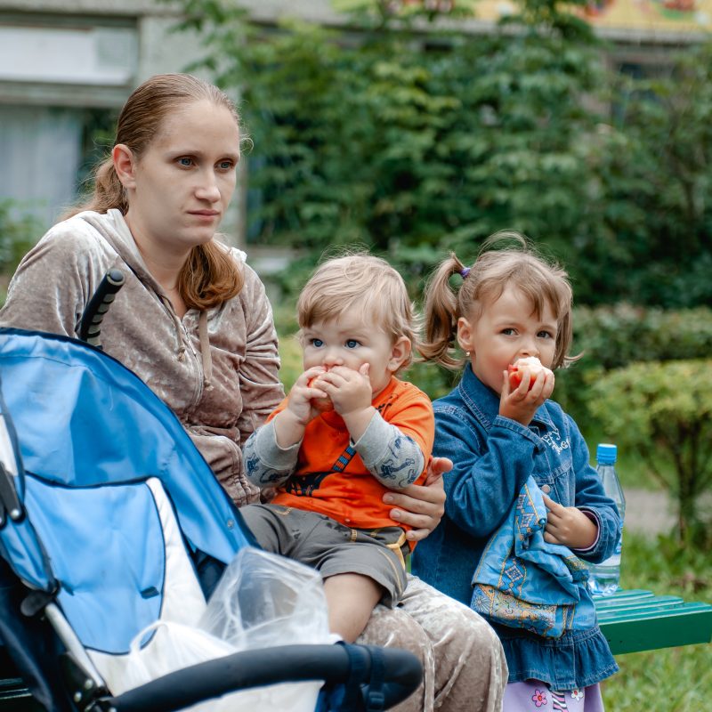 a-young-mother-and-her-two-children-are-walking-on